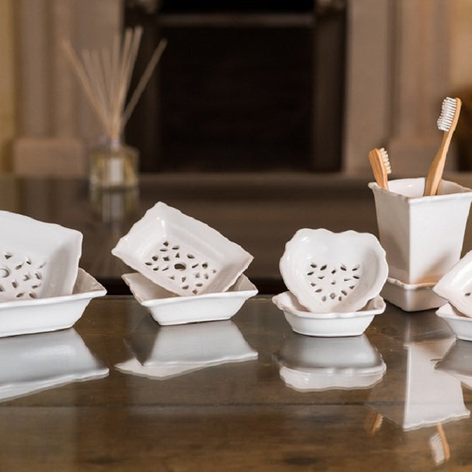 Set of double-layered, draining soap dishes with pretty geometric pattern cut into the top dish to provide drainage onto the bottom dish.