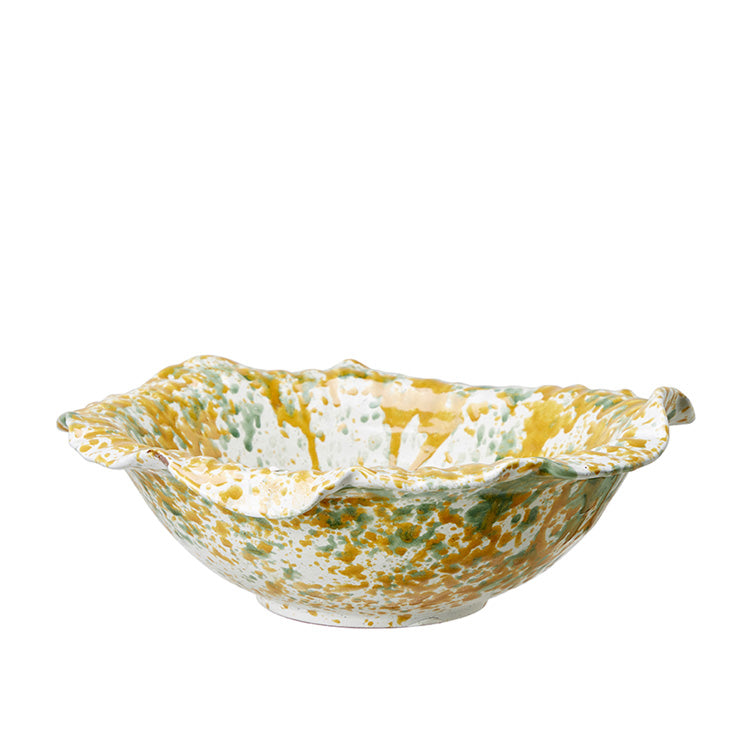 A yellow and green melange terracotta bowl with a leaf pattern.
