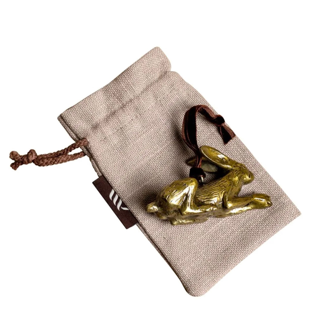 Brass hare-shaped hanging Christmas decoration on linen gift bag.