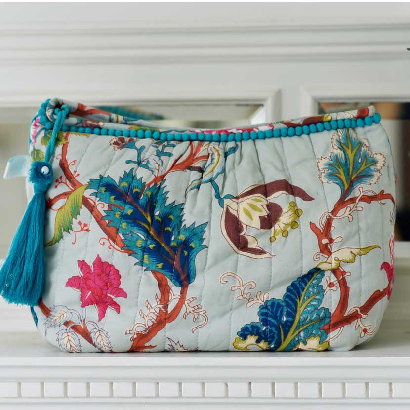 Blue floral print wash bag with blue tassel and blue edging.