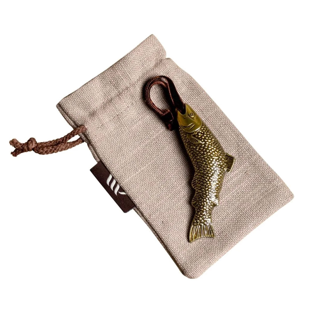 Brass fish-shaped hanging ornament on linen gift bag.