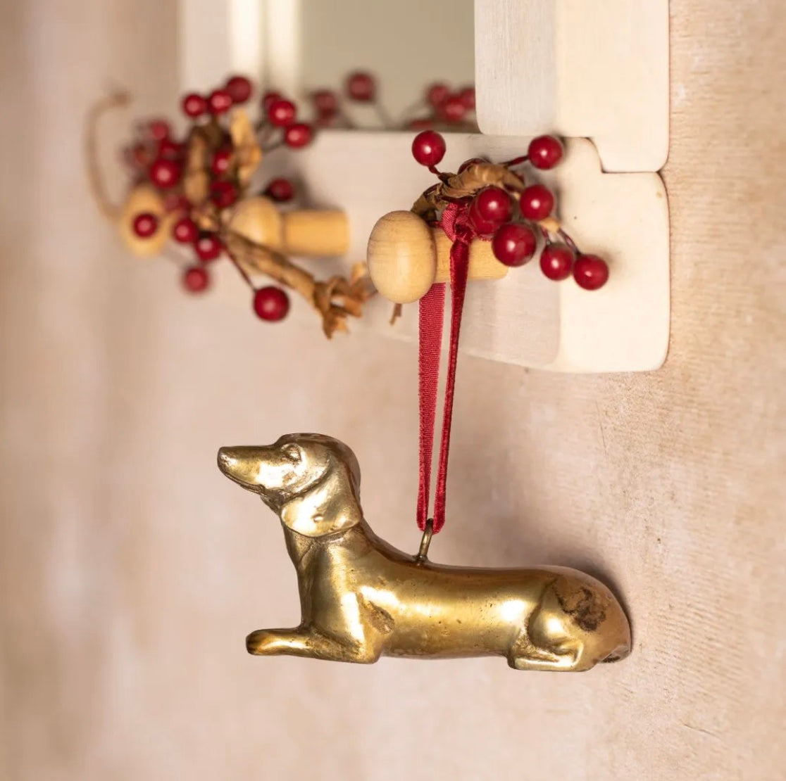 Brass Dachshund-shaped hanging Christmas decoration.