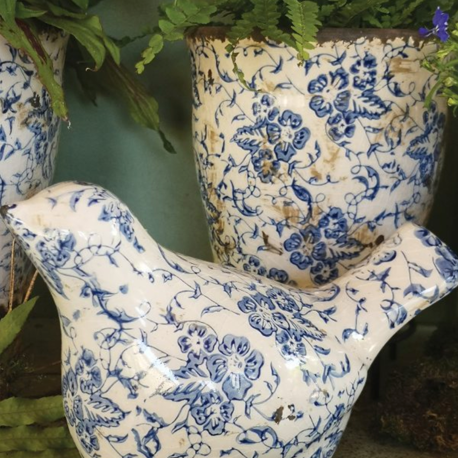 Ceramic bird ornament with slightly distressed blue floral pattern