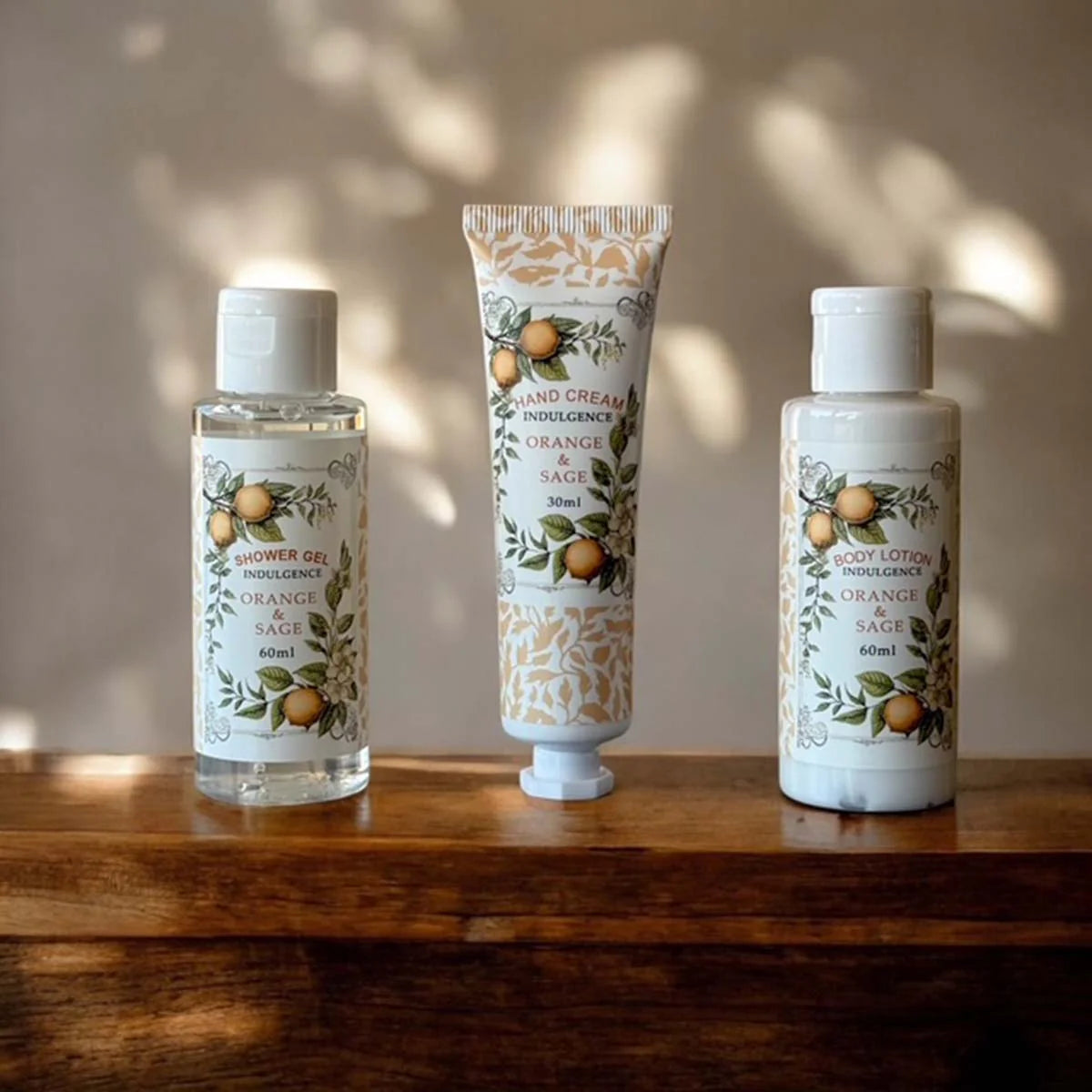 Three skincare products in orange and sage scent.