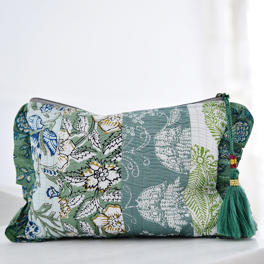 Green patchwork print wash bag with green tassel.