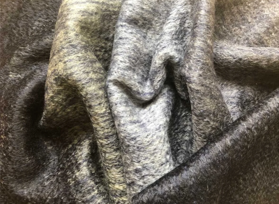 Detail of The Black Face Sheep's Jet mohair throw is made using traditional weaving methods. The ombre design moves from navy to silver. The special drawn finish creates exceptional warmth and lustre.