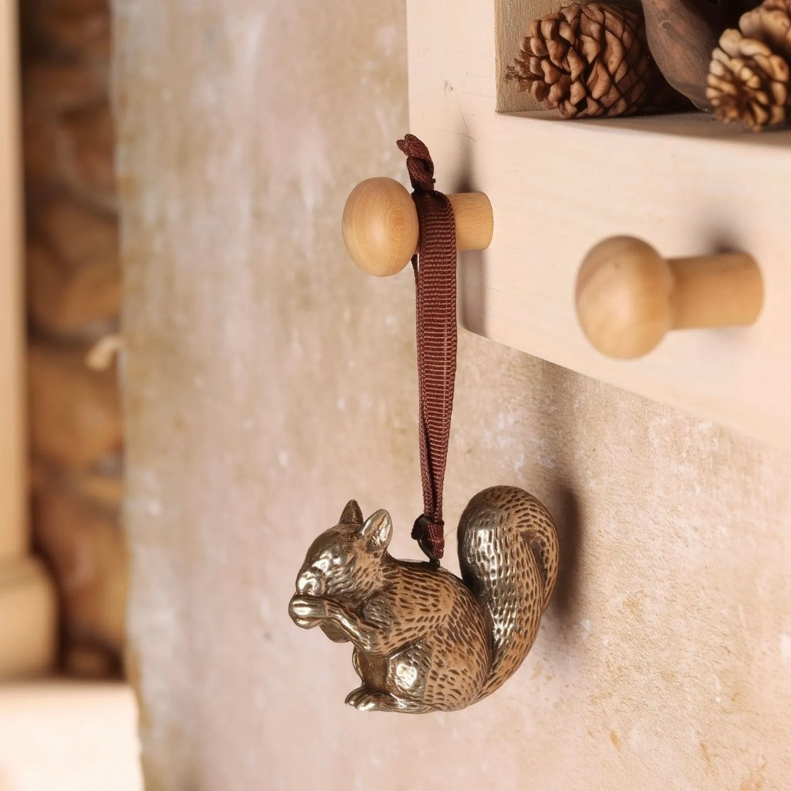 Brass squirrel-shaped hanging Christmas decoration.