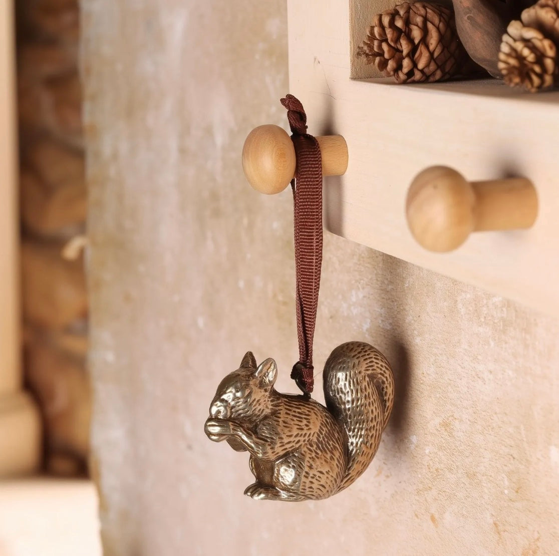 Brass squirrel-shaped hanging Christmas decoration.