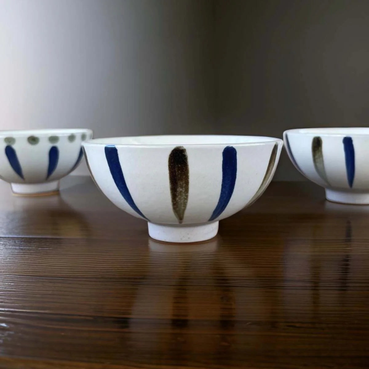 White ceramic bowl with grey and white stripes.