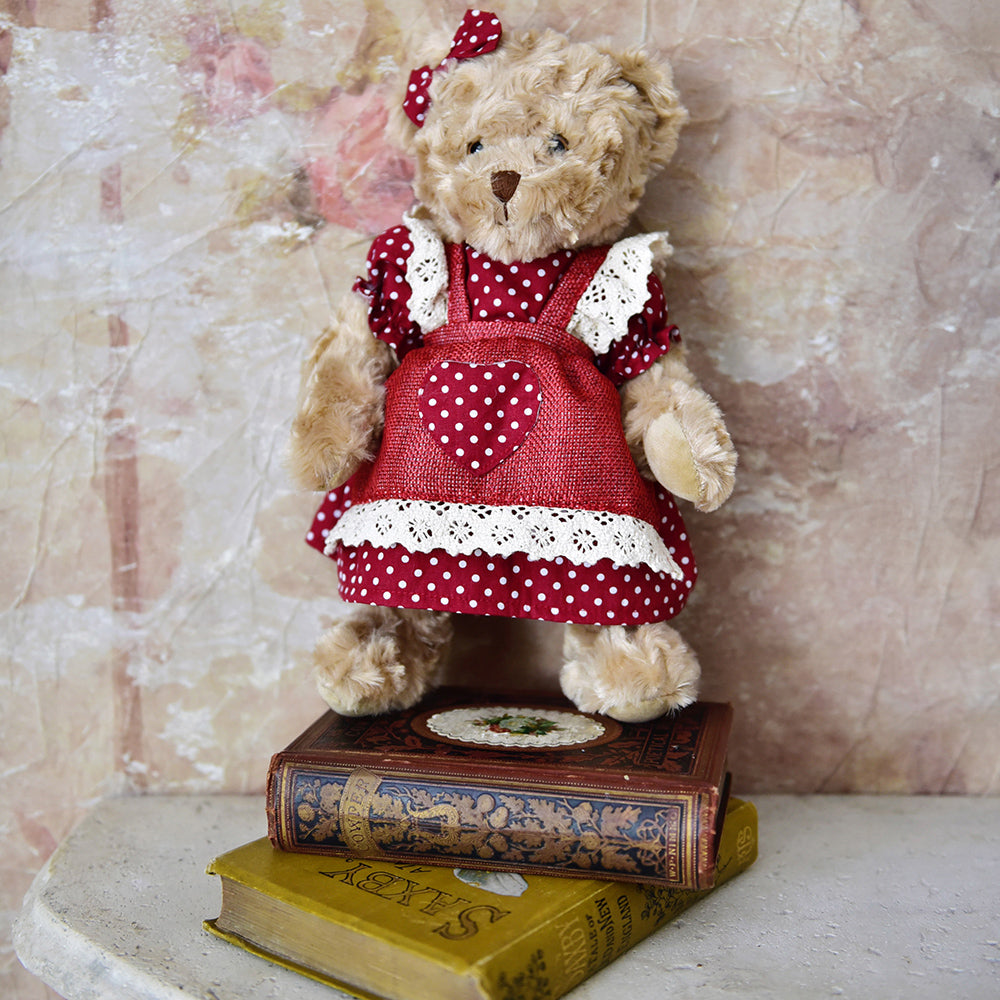 Teddy bear in red and white polka dot dress.