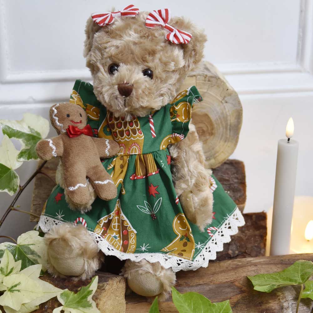 Fluffy teddybear in a gingerbread printed green dress.