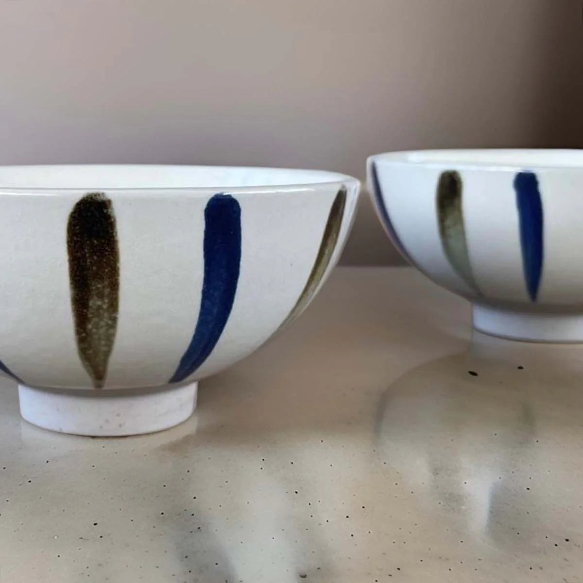 White ceramic bowl with grey and white stripes.