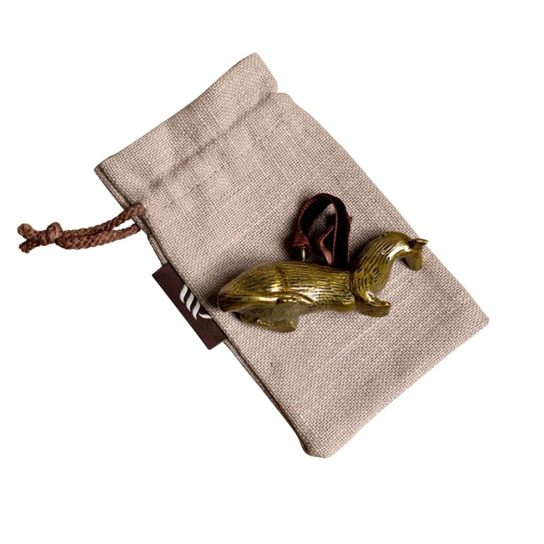 Brass otter-shaped hanging Christmas ornament on linen gift bag.