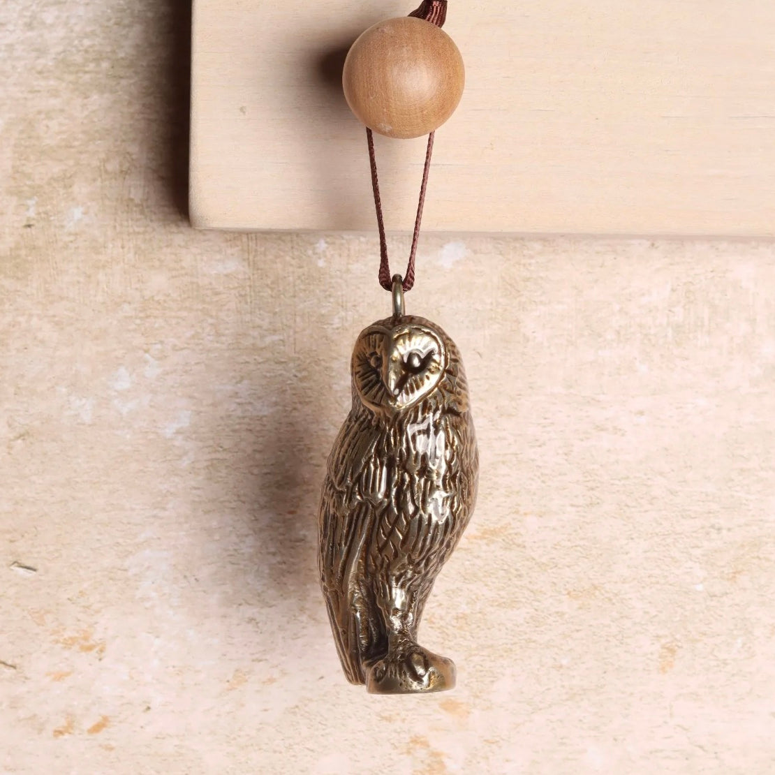 Brass owl shaped hanging decoration.