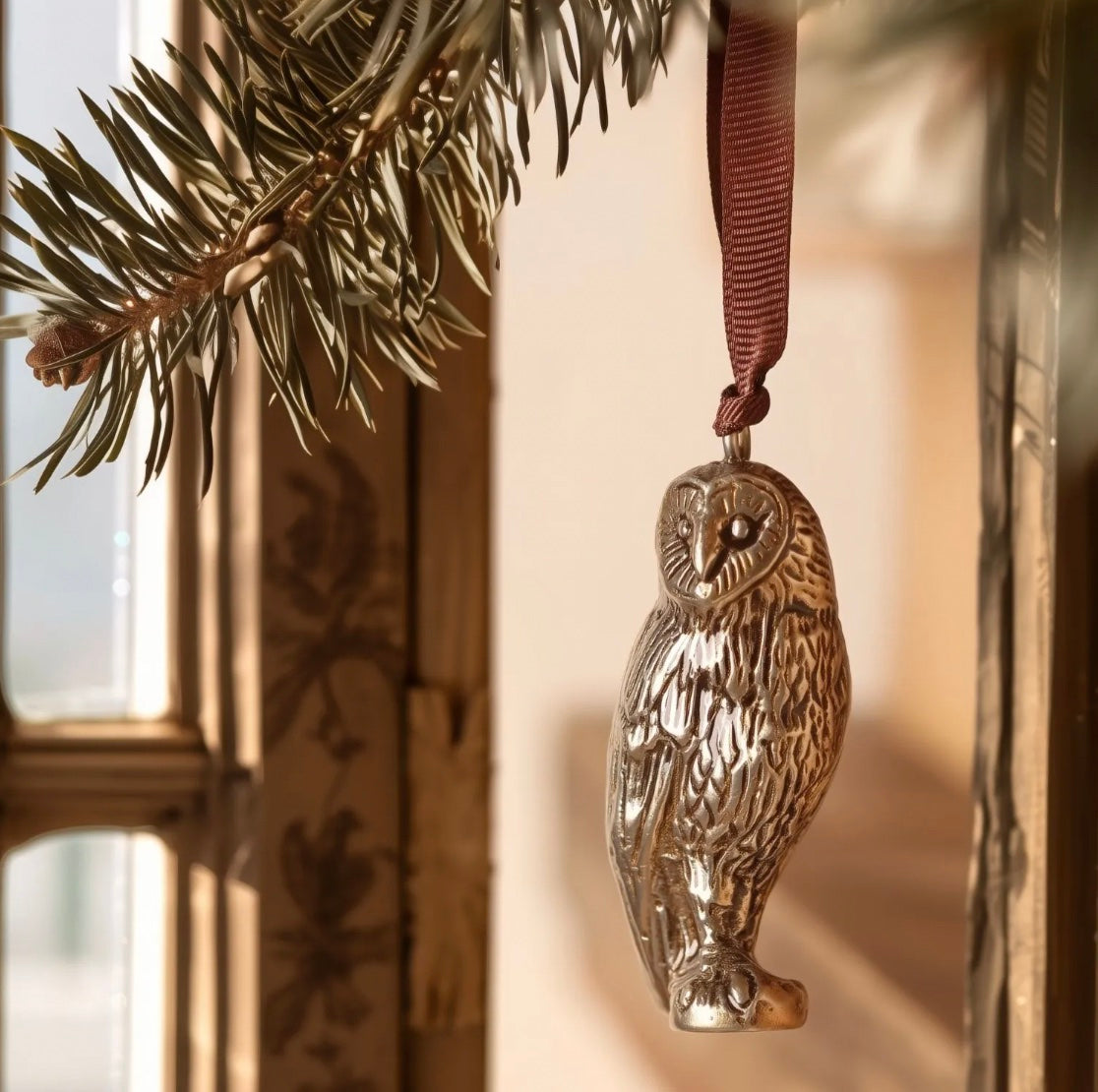 Brass owl shaped hanging decoration.