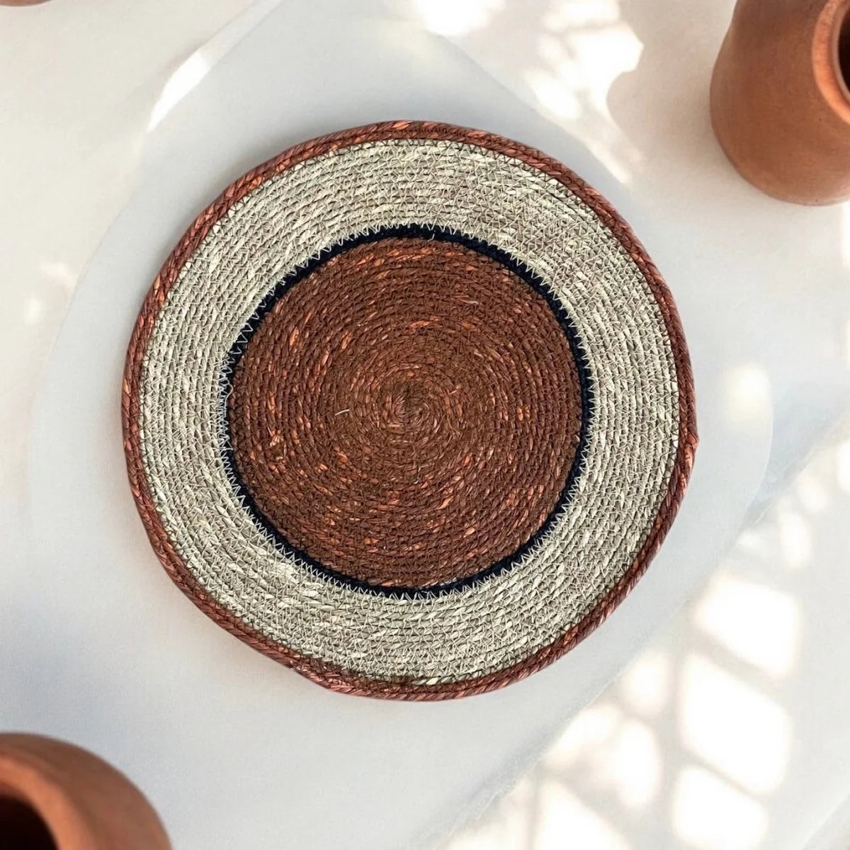 Orange round woven placemat.