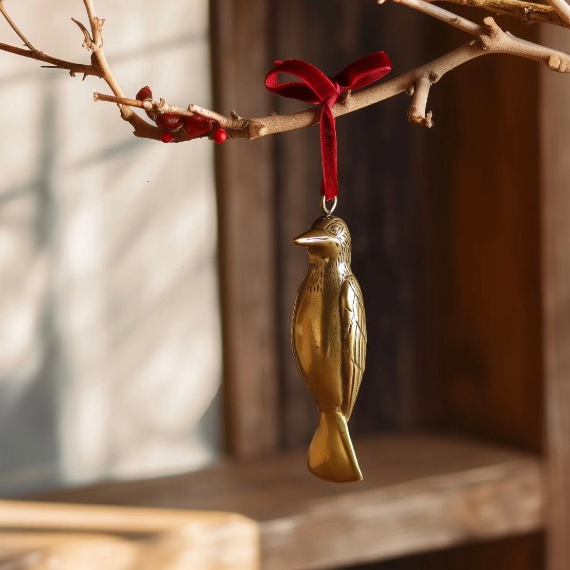 Brass woodpecker-shaped hanging Christmas ornament.