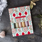Box of assorted bath salts with decorative packaging.
