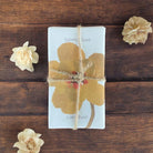 Scented soap tied with twine in a floral design wrapper.