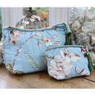 Blue wash bag with blossom print and green tassel.