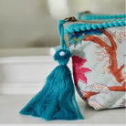 Blue floral print makeup bag with blue tassel.