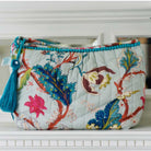 Blue floral print wash bag with blue tassel and blue edging.