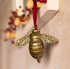 Brass bee-shaped hanging ornament.