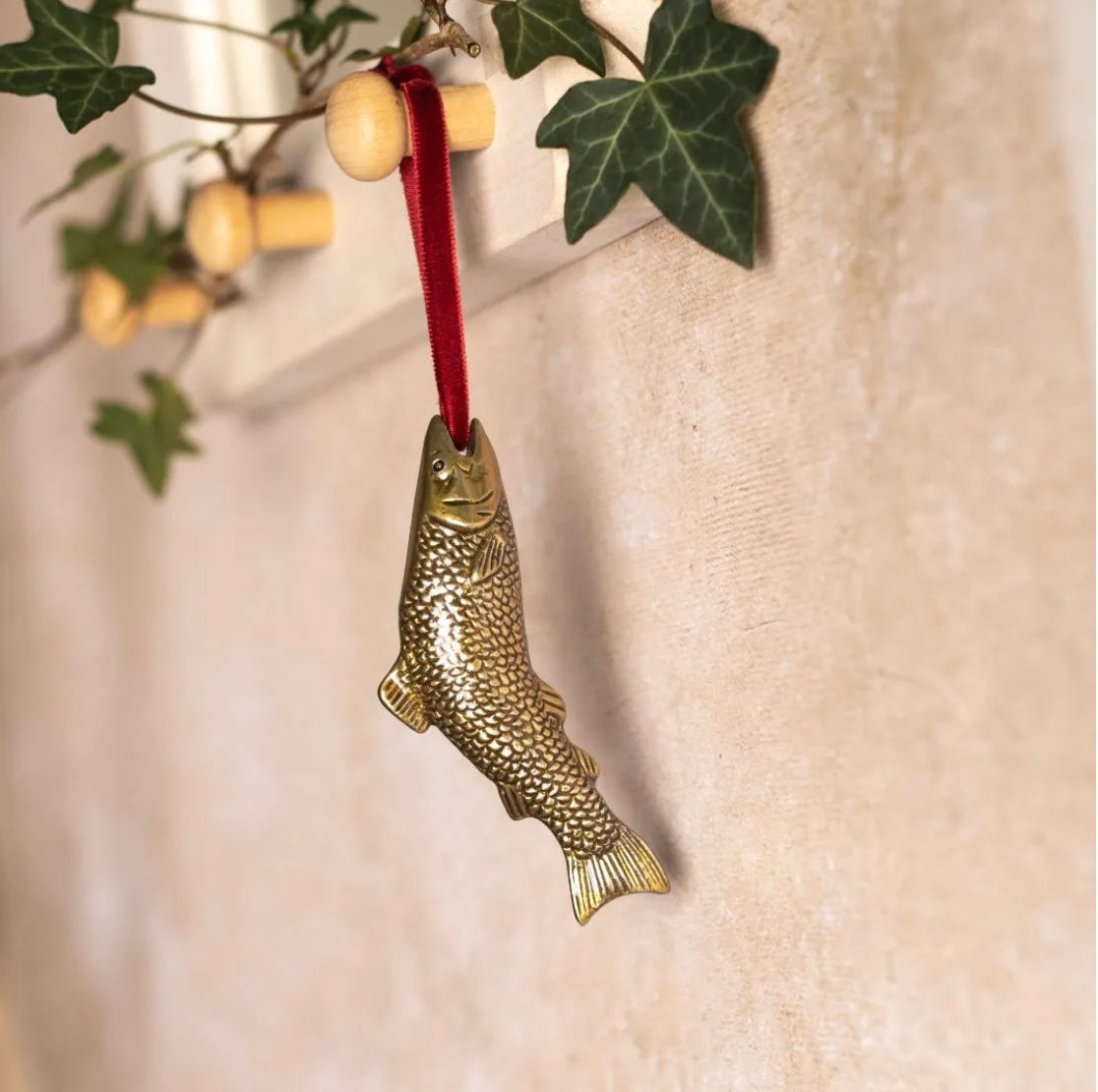 Brass fish-shaped hanging Christmas decoration.