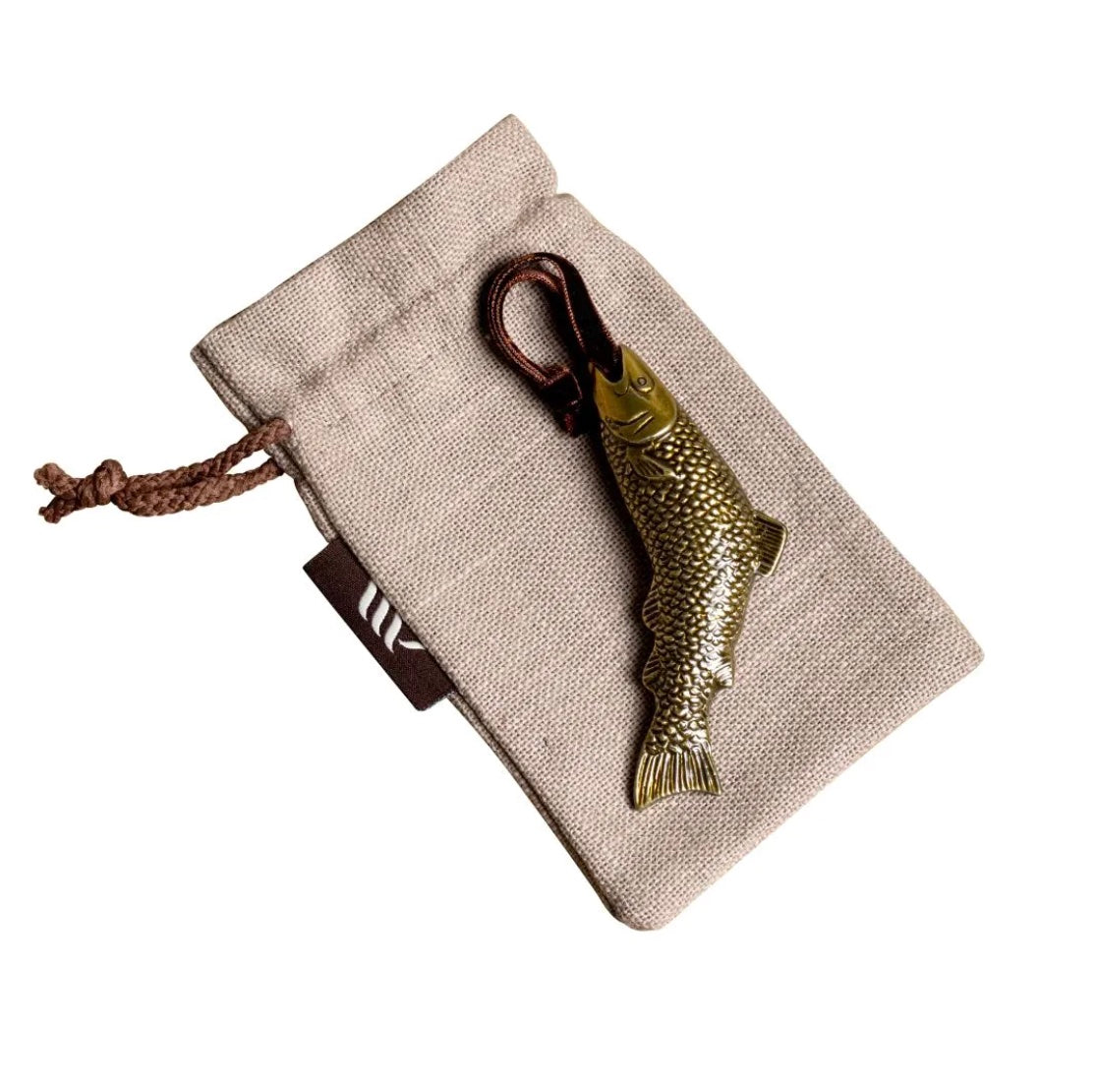 Brass fish-shaped hanging ornament on linen gift bag.