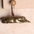 Brass hanging Greyhound-shaped ornament.