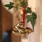 Brass hare-shaped hanging Christmas ornament.