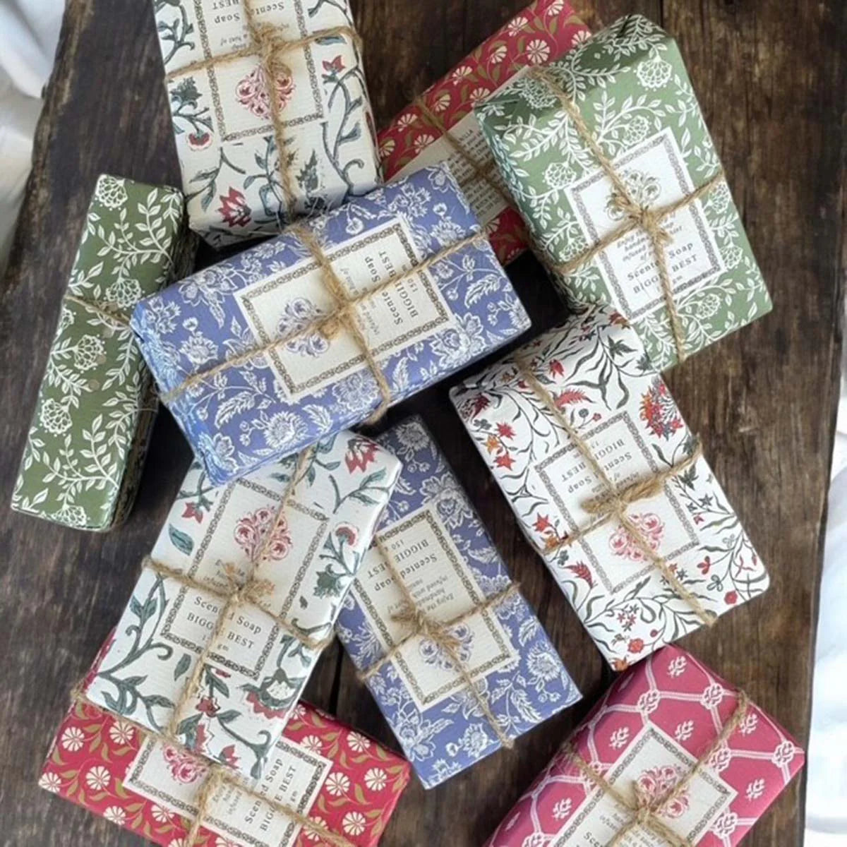 Collection of soap bars in decorative wrappers tied with jute string.
