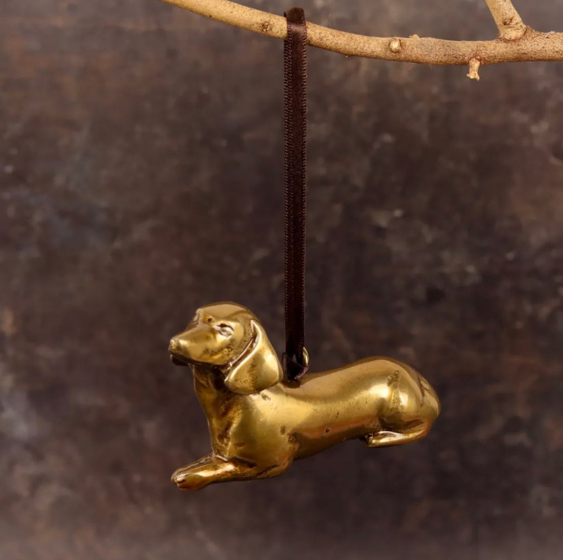Brass Dachshund-shaped hanging decoration.