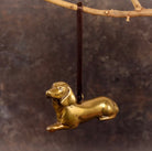 Brass Dachshund-shaped hanging decoration.
