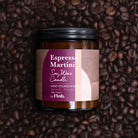 Candle jar labeled 'Espresso Martini' on a background of coffee beans