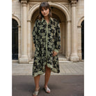 Patterned knee length shirt dress in black and gold.