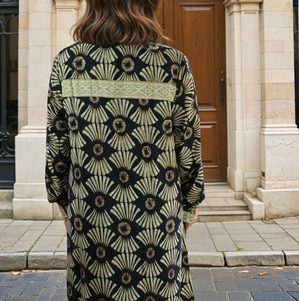 Patterned knee length shirt dress in black and gold.