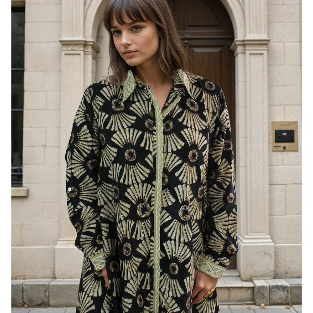 Patterned knee length shirt dress in black and gold.
