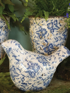 Ceramic bird ornament with slightly distressed blue floral pattern 