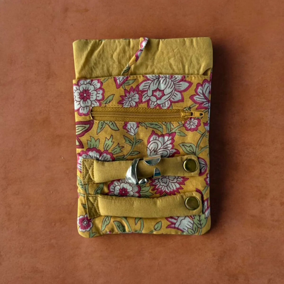 Yellow floral fabric jewellery roll.