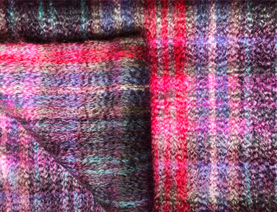 Detail of pattern in our traditionally made Scottish Mohair Throw in Sloeberry Colours, pink, red, purple.