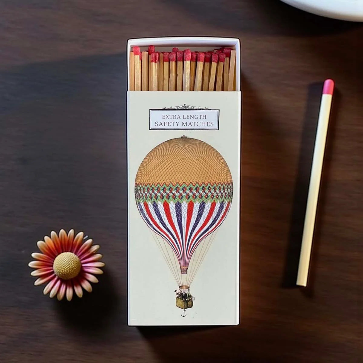 Matchbox with hot air balloon design.