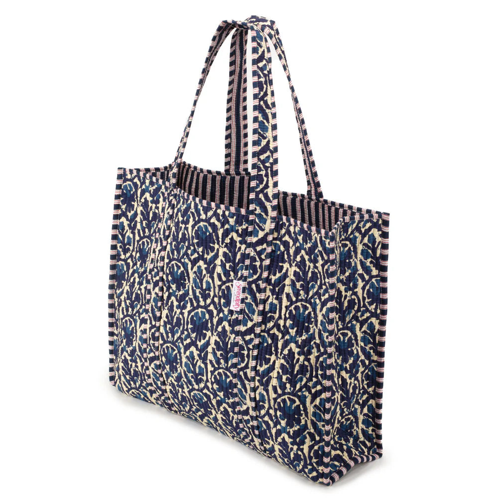 Patterned tote bag with a visible brand logo on a white background
