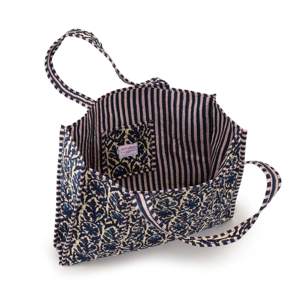Multicolored fabric bag with a striped interior on a white background