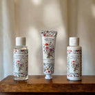 Three skincare products with floral designs, scented with lavender and eucalyptus.