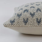 Mhari textured cushion with blue heart pattern on a white background.