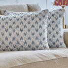 Mhari decorative cushions with blue heart design on neutral background on a beige sofa.