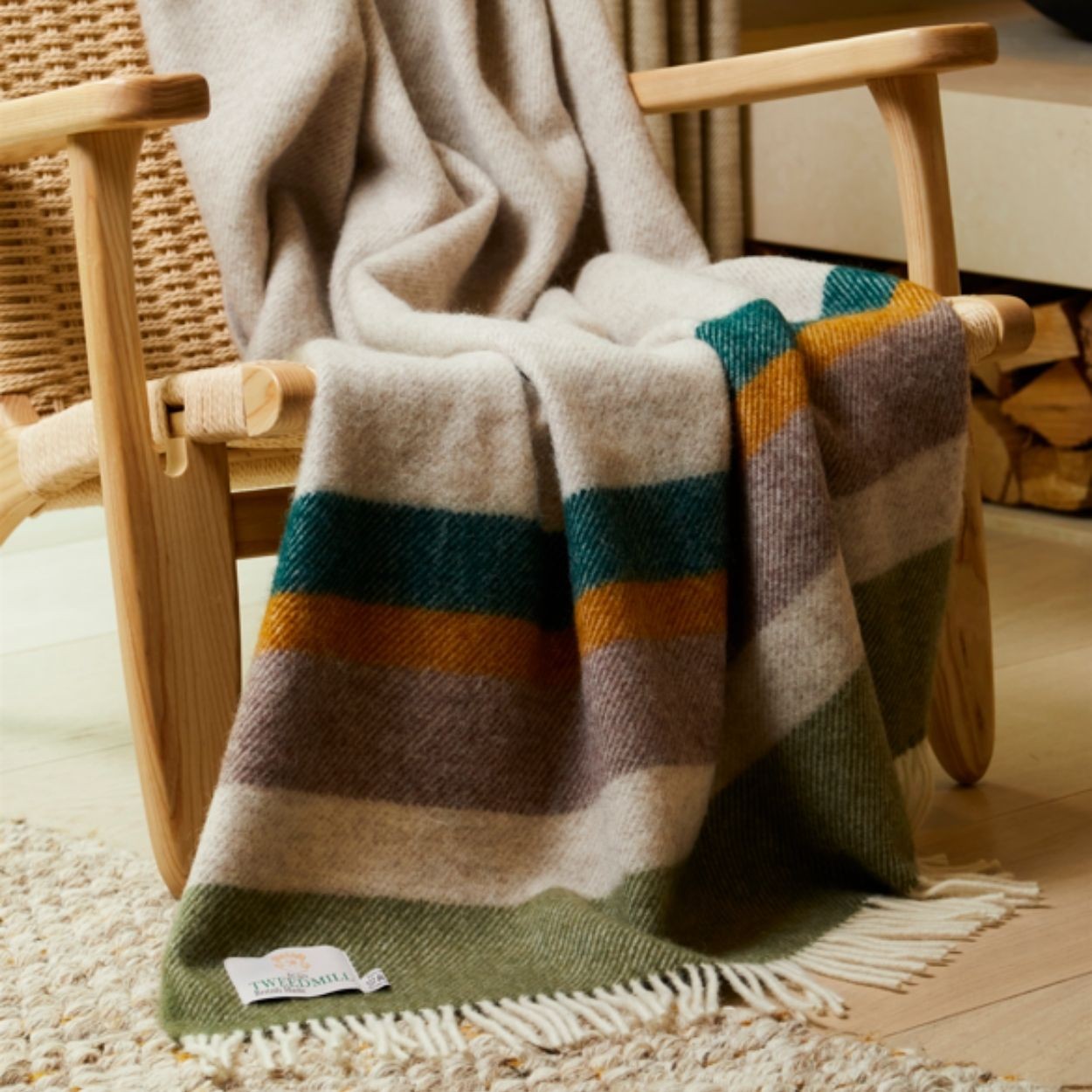 Striped blanket draped over a wooden chair with a visible brand label.