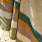 Close-up of pure new wool throw with green, brown, and yellow colors.