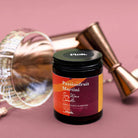 Candle jar labeled 'Passionfruit Martini' by Floh on a pink background